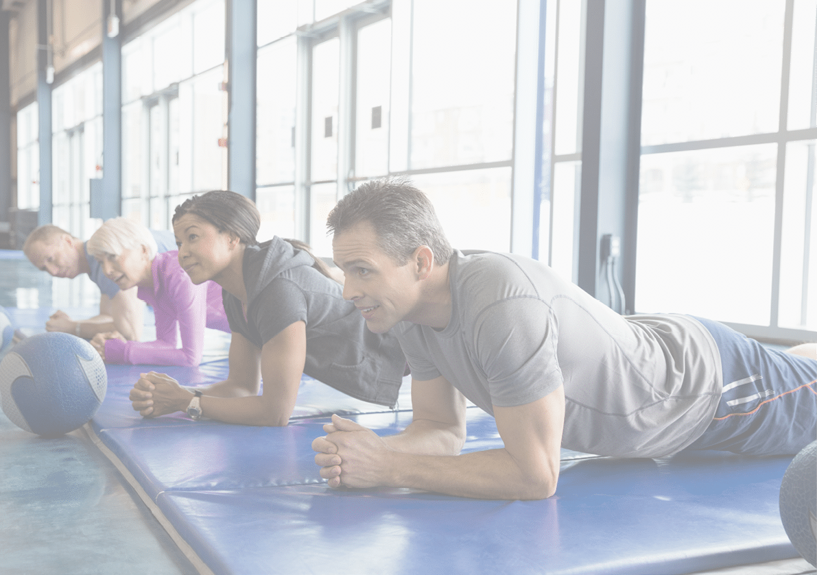 Group doing planks in exercise class at gym